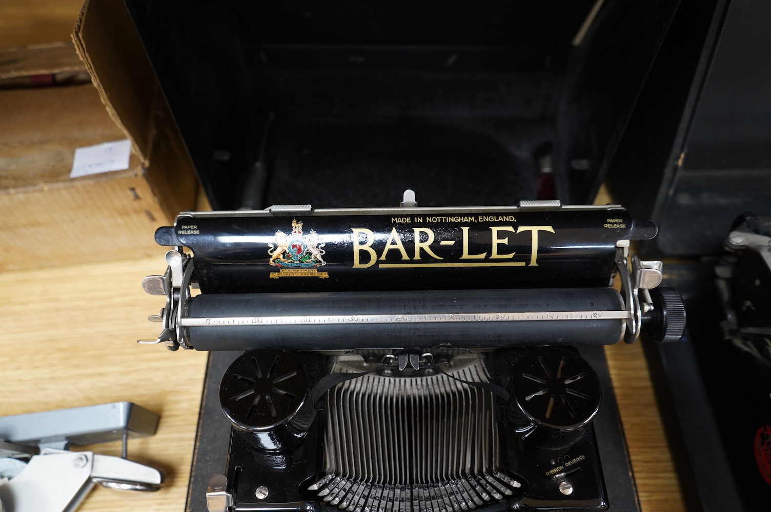 A Peoples Champion Indexing Typewriter, circa 1893, by the Garvin Machine Co., New York, on a mahogany plinth, with black tin cover, inscribed ‘’PEX’’ CHAMPION, width 28cm; a Bar-Let vintage typewriter, cased; an Underwo